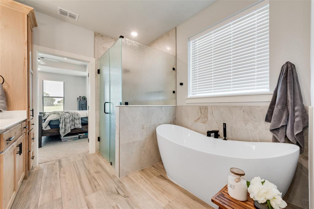 12880 Pruett Road Krum, TX 76249 - Photo 13 of 27 a bathroom with a bathtub and a sink