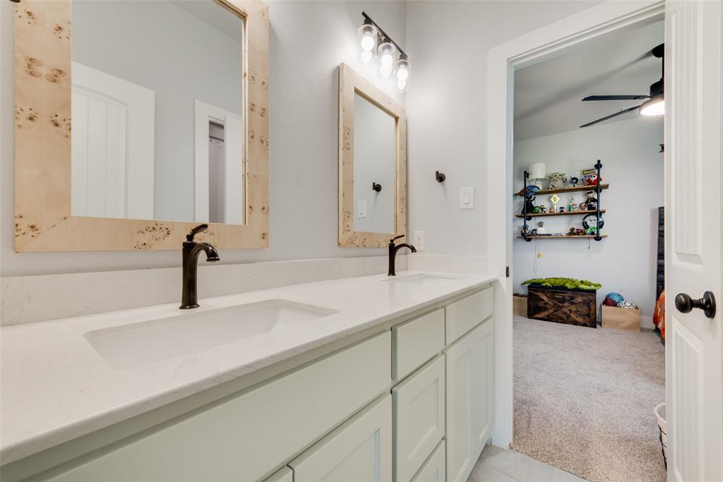 12880 Pruett Road Krum, TX 76249 - Photo 18 of 27 a bathroom with a sink and a mirror
