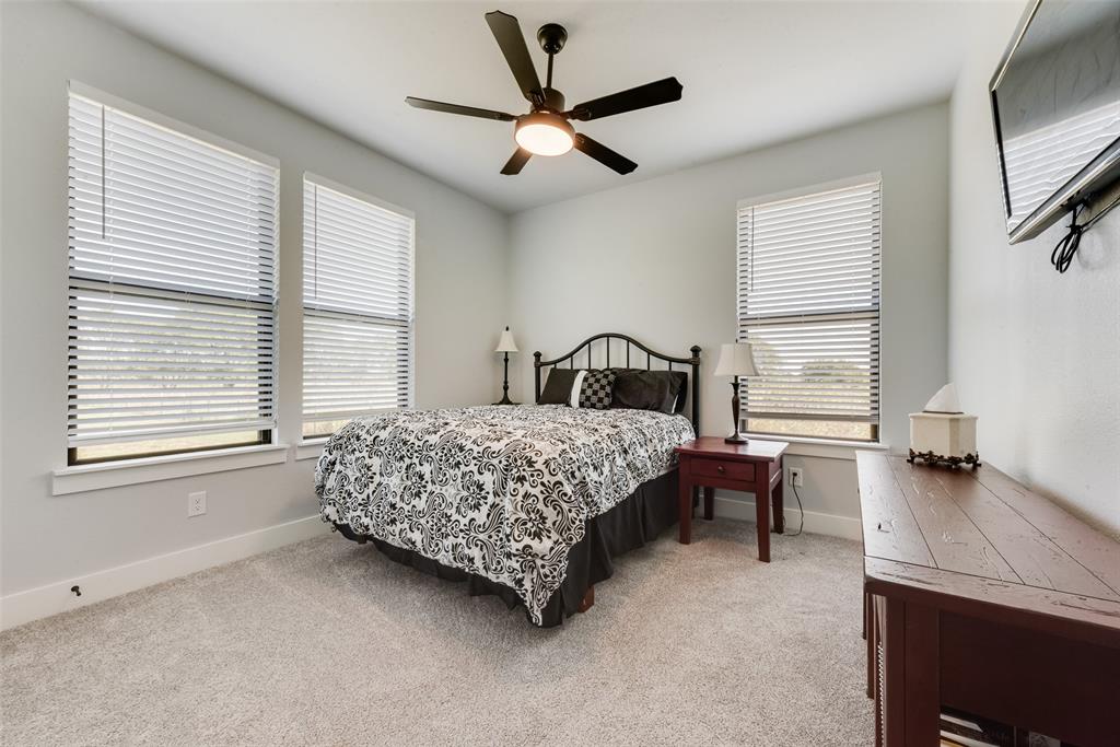 12880 Pruett Road Krum, TX 76249 - Photo 20 of 27 a bedroom with a bed window and a table