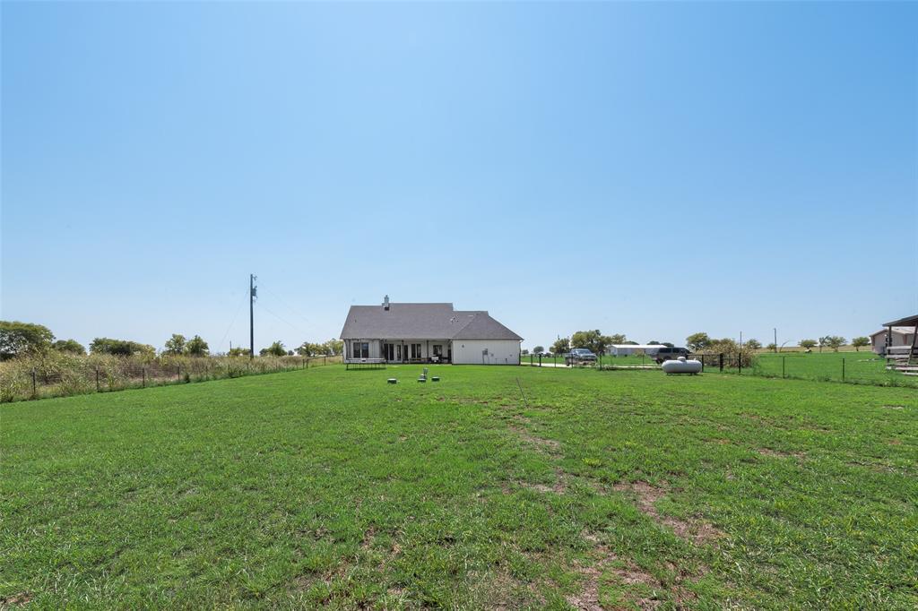 12880 Pruett Road Krum, TX 76249 - Photo 26 of 27 a view of a grassy field with an trees