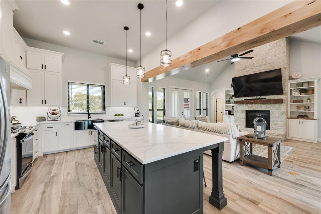 12880 Pruett Road Krum, TX 76249 - Photo 4 of 27 a large kitchen with a table chairs stove and cabinets