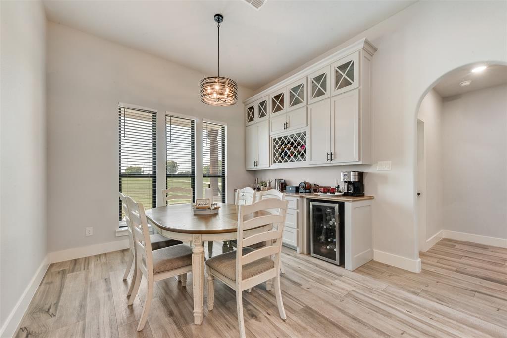 12880 Pruett Road Krum, TX 76249 - Photo 10 of 27 a view of a dining room with furniture window and wooden floor