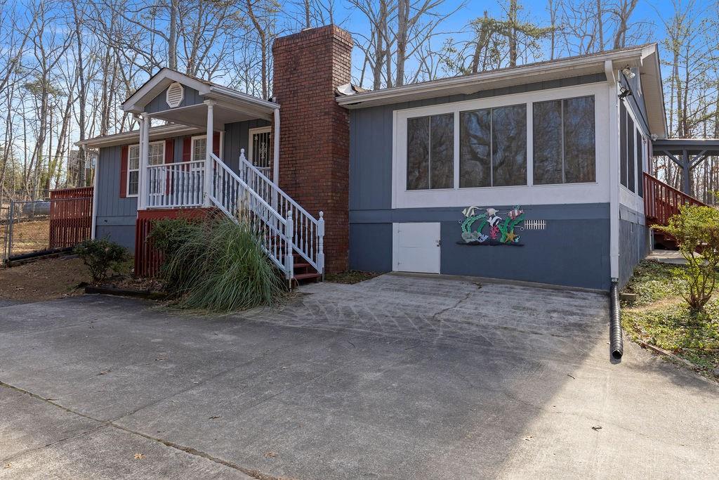 6449 Paradise Point Road Flowery Branch, GA 30542 - Photo 1 of 1 a view of a house with a yard