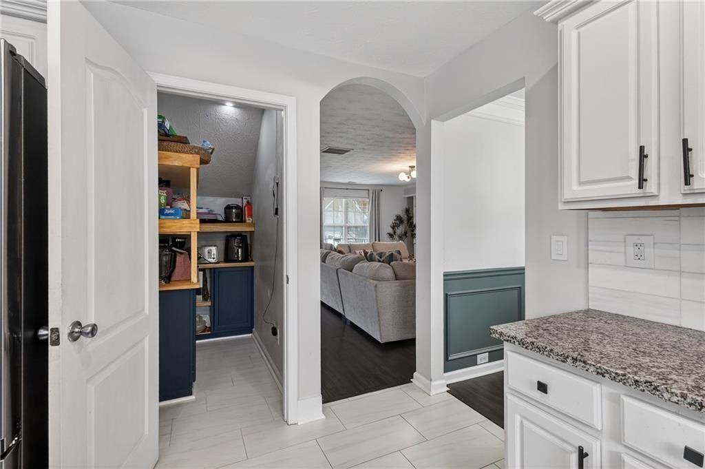 2787 Riders Court Northeast Dacula, GA 30019 - Photo 11 of 26 a kitchen with stainless steel appliances granite countertop a refrigerator and a sink
