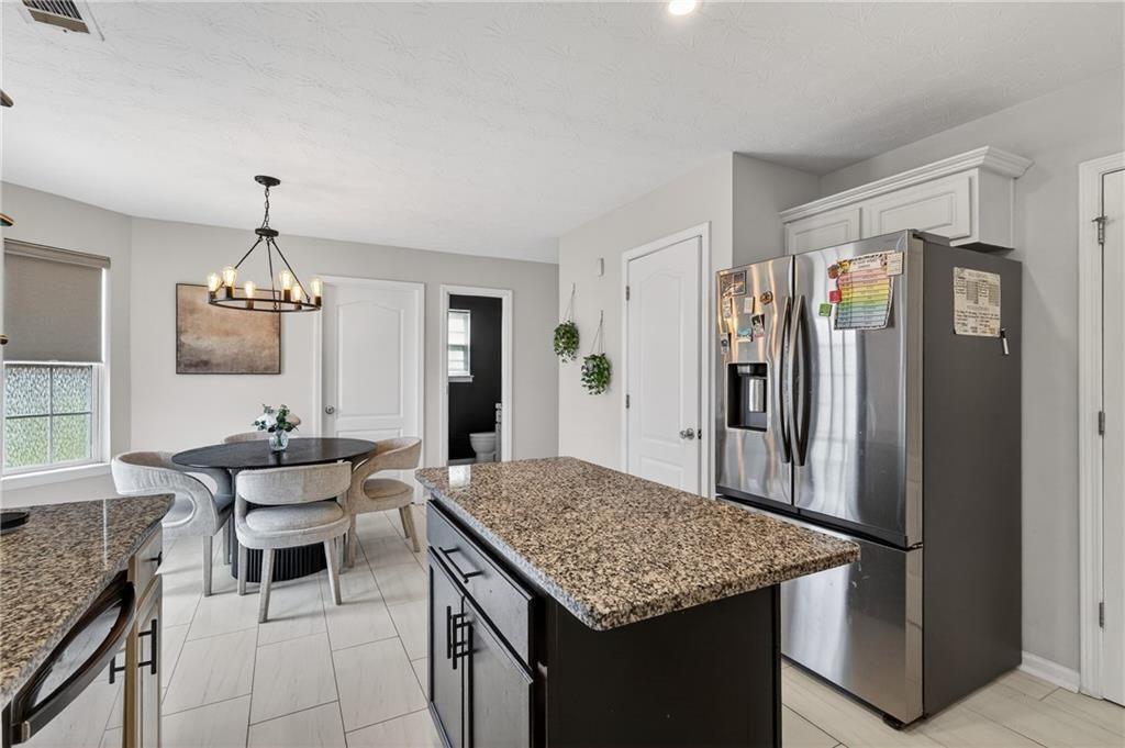 2787 Riders Court Northeast Dacula, GA 30019 - Photo 13 of 26 a kitchen with a table and refrigerator