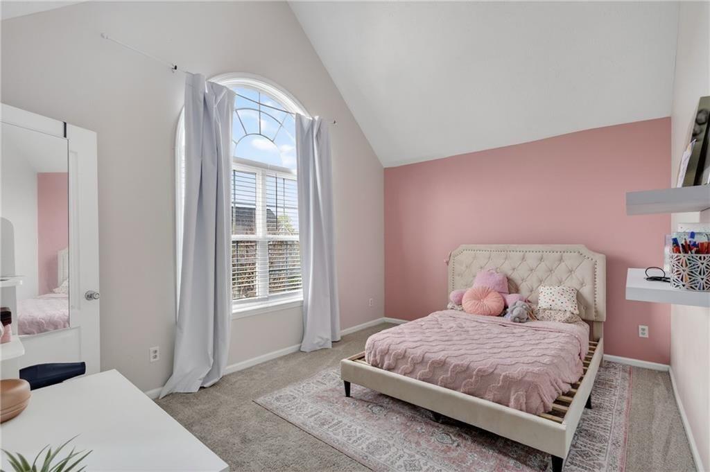 2787 Riders Court Northeast Dacula, GA 30019 - Photo 20 of 26 a bedroom with a bed and a window