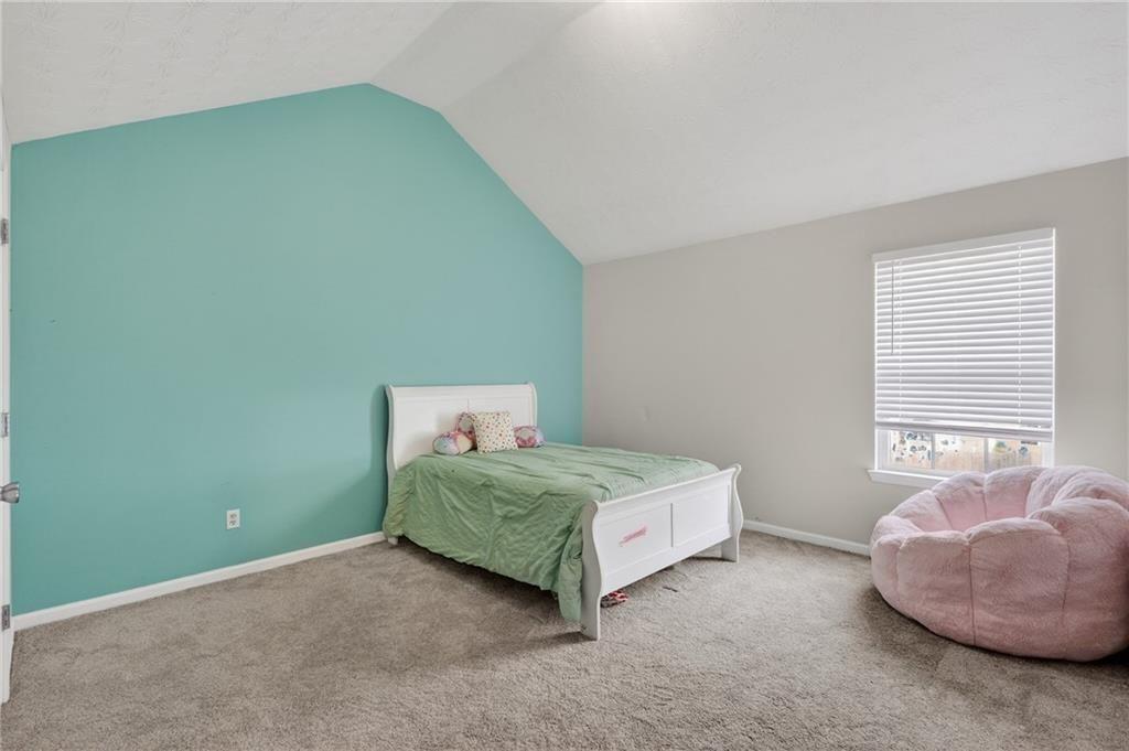 2787 Riders Court Northeast Dacula, GA 30019 - Photo 22 of 26 a room with a bed and a window