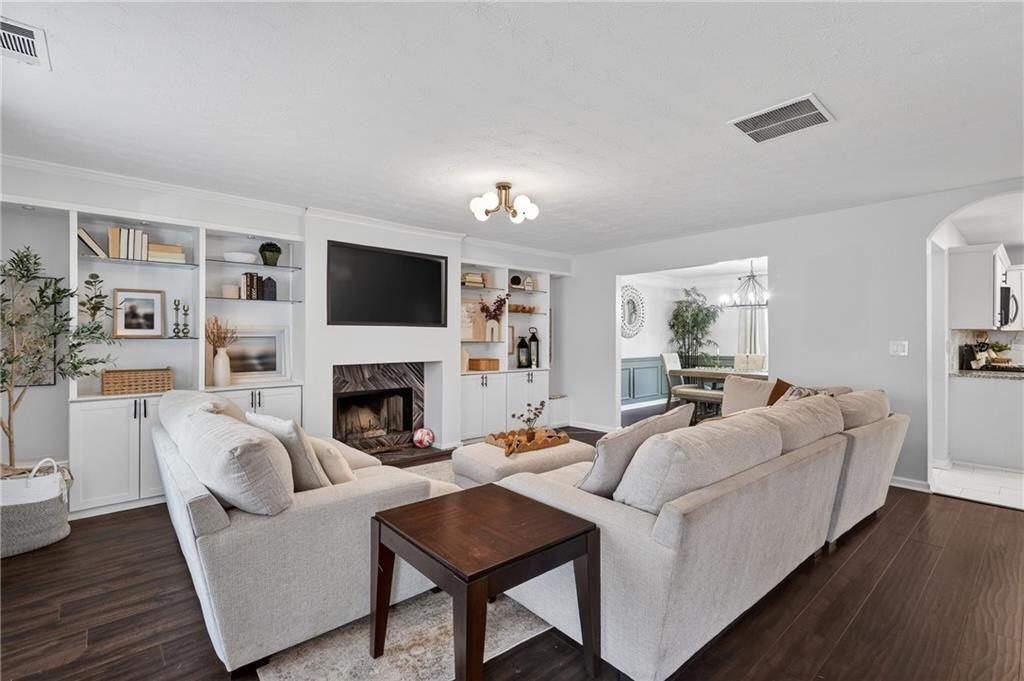2787 Riders Court Northeast Dacula, GA 30019 - Photo 7 of 26 a living room with furniture a fireplace and a flat screen tv
