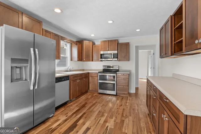 a kitchen with stainless steel appliances cabinets a sink and a stove