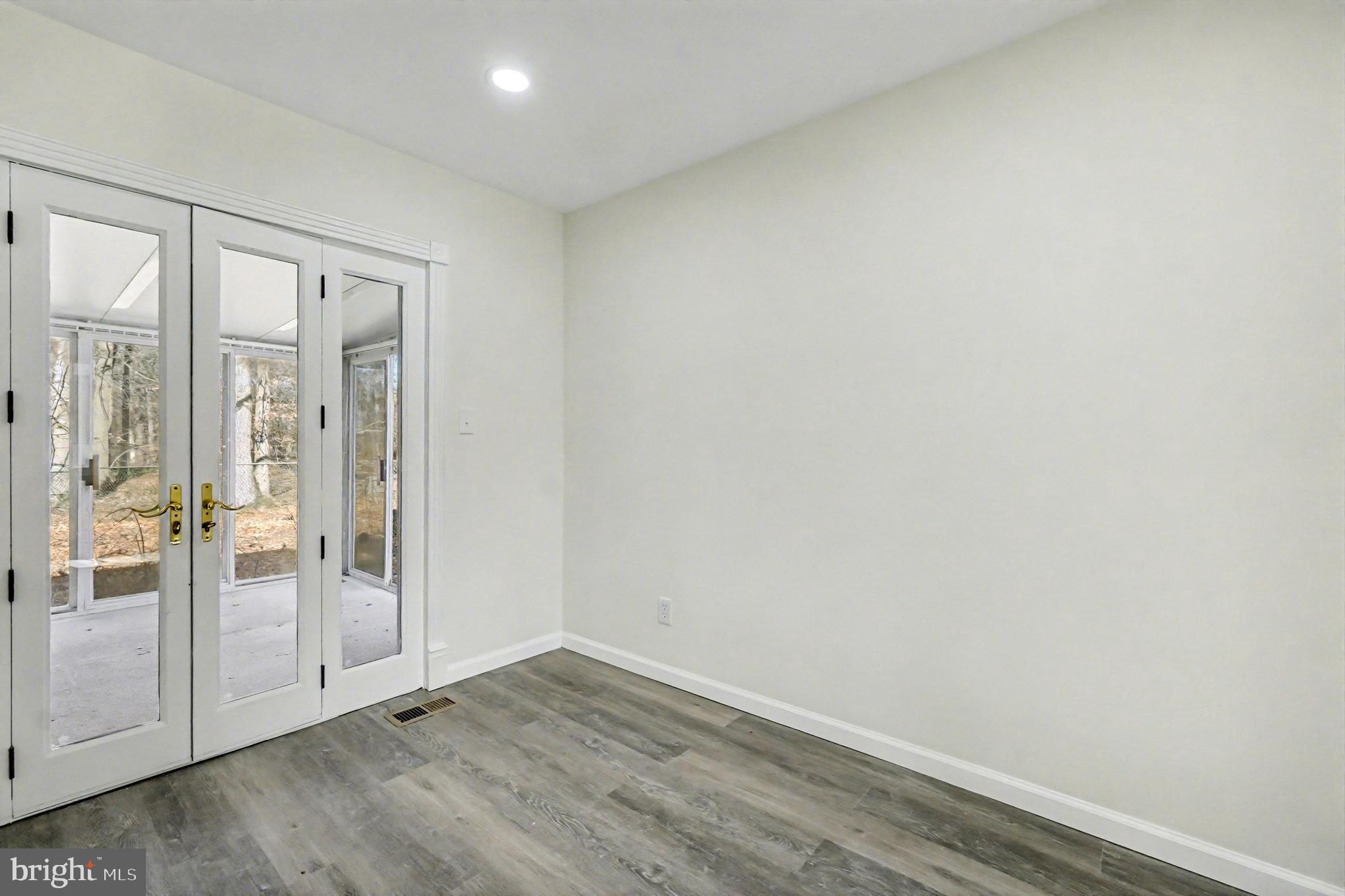 661 Pilot Town Road Conowingo, MD 21918 - Photo 27 of 38 an empty room with wooden floor and door