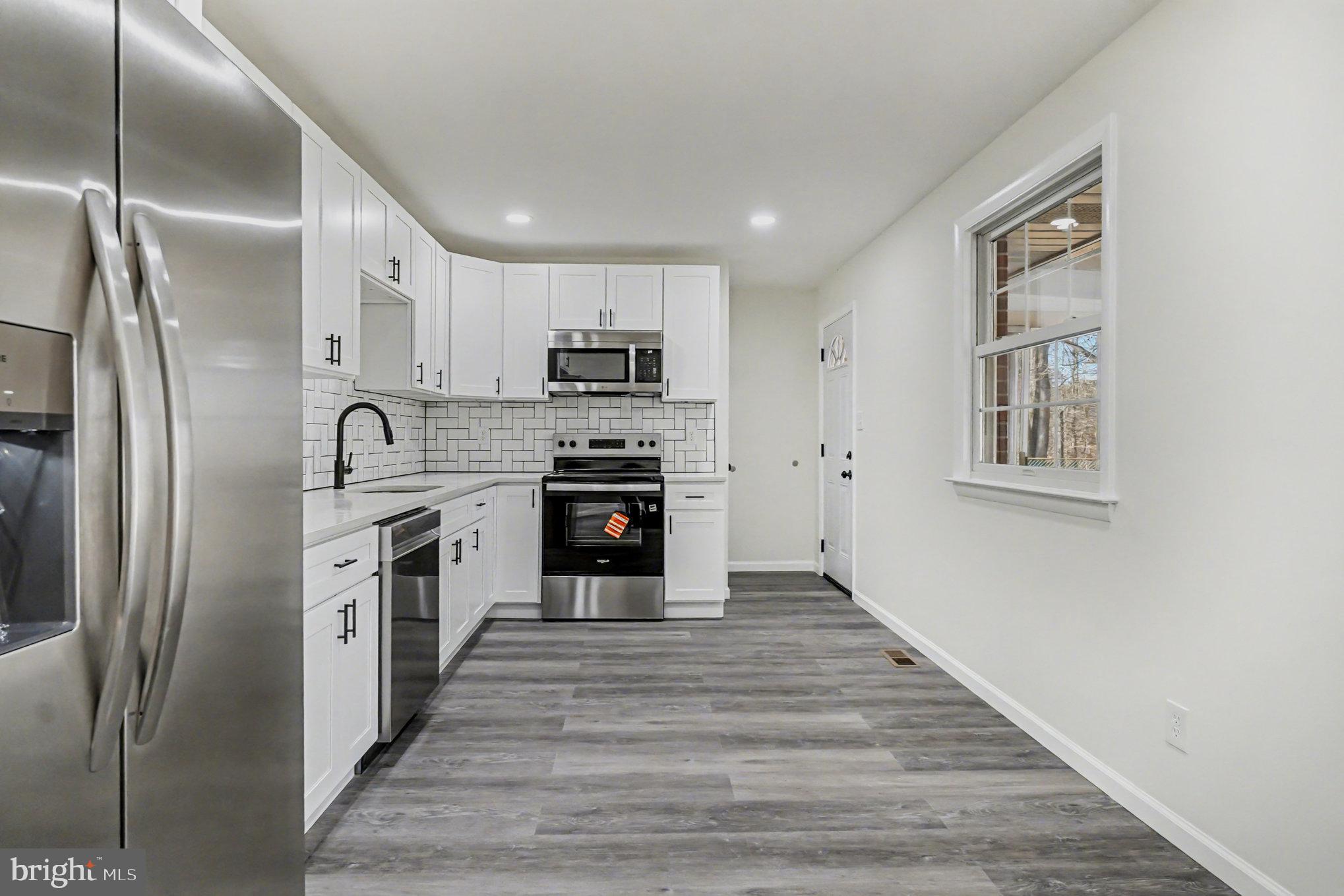 661 Pilot Town Road Conowingo, MD 21918 - Photo 6 of 38 a kitchen with stainless steel appliances a refrigerator sink and cabinets