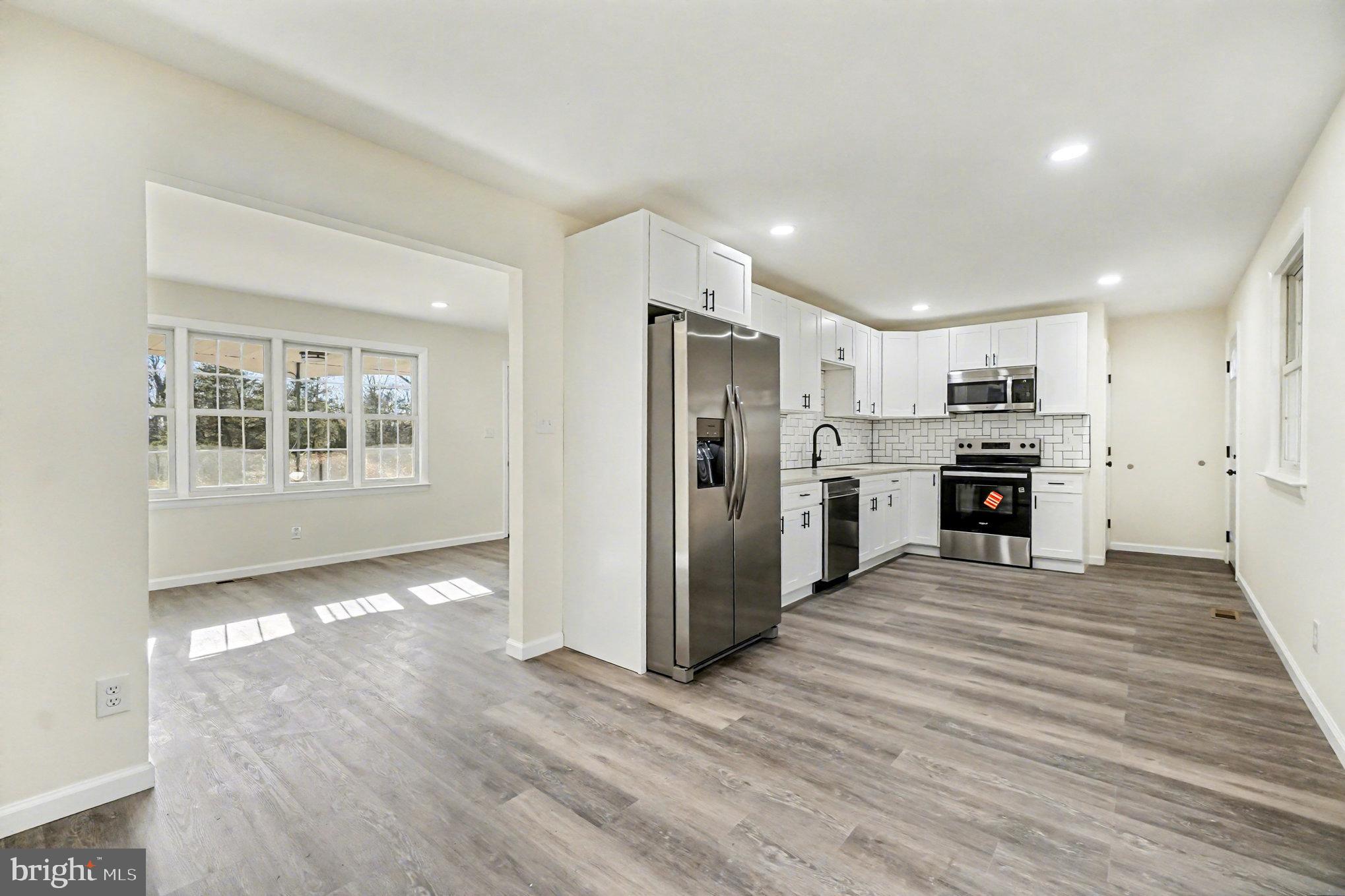 661 Pilot Town Road Conowingo, MD 21918 - Photo 7 of 38 a view of kitchen with kitchen island wooden floor appliances and cabinets
