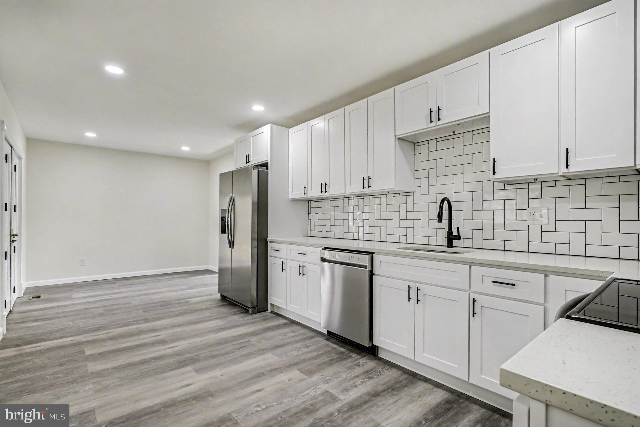 661 Pilot Town Road Conowingo, MD 21918 - Photo 8 of 38 a kitchen with a sink a refrigerator and cabinets