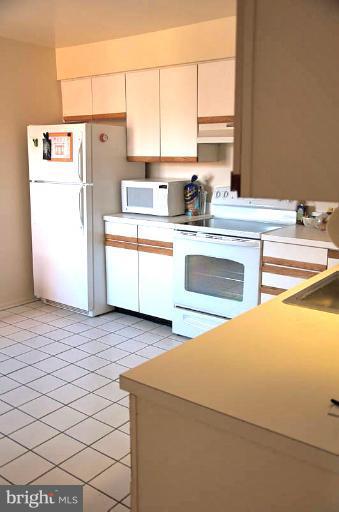 2903 Fallstaff Road, Unit 408 Baltimore, MD 21209 - Photo 4 of 8 a kitchen with a sink cabinets and window