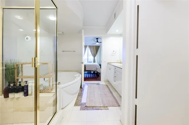 a en suite bathroom with a tub shower and a sink