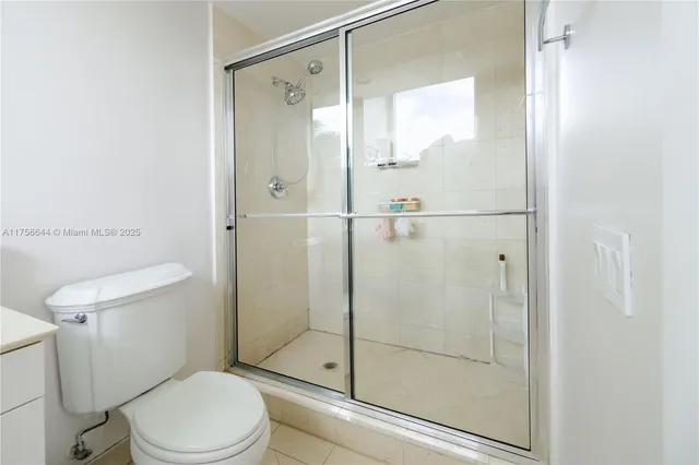 a bathroom with a shower a toilet and a sink