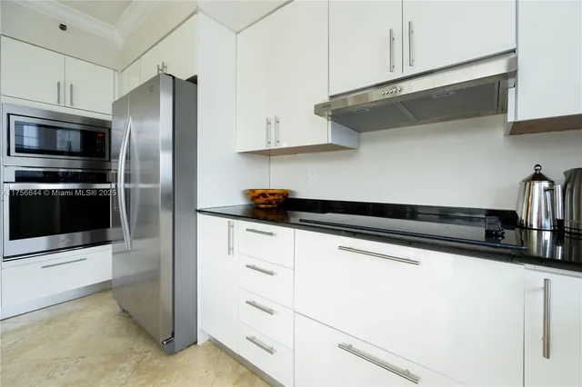 a kitchen with stainless steel appliances a sink and a refrigerator