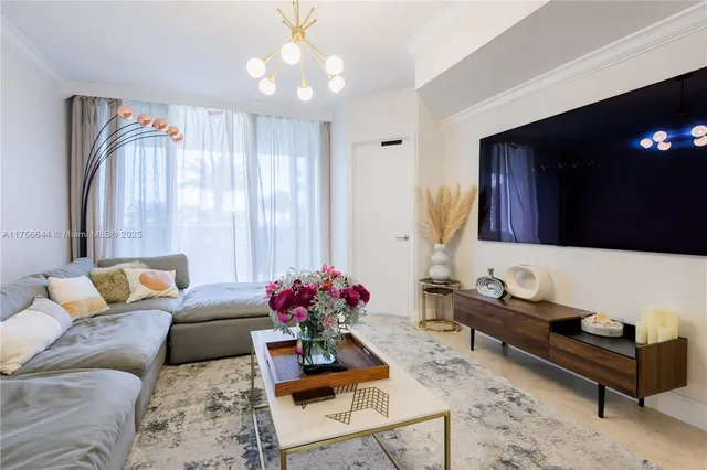 a living room with furniture and a chandelier