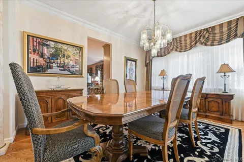 a view of a dining room with furniture and chandelier