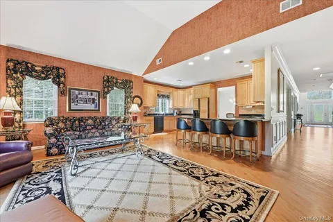 a living room with lots of furniture and a large mirror