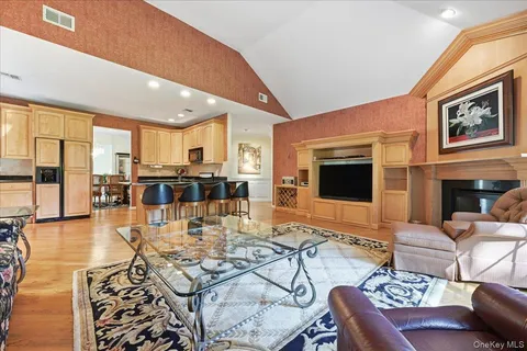 a living room with fireplace furniture and a large window