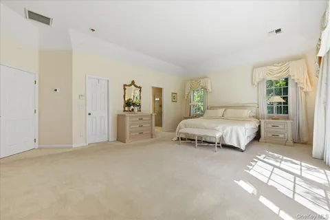 a spacious bedroom with a bed and a couch