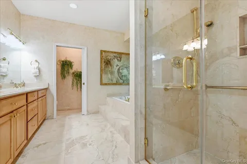 a bathroom with a double vanity sink mirror and shower