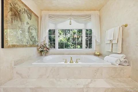 a bathroom with a bathtub and a window