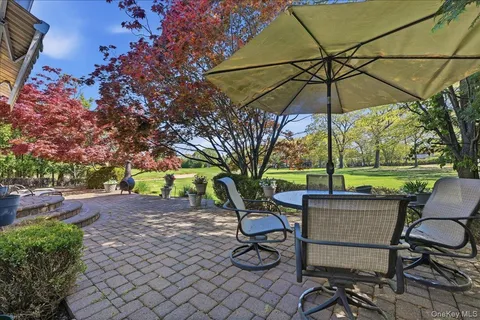a view of a table and chairs under an umbrella