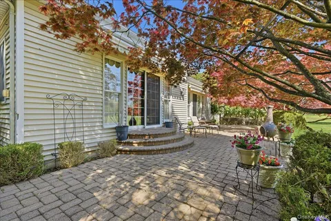 a backyard of a house with outdoor seating