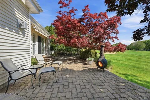 a view of a backyard with sitting area