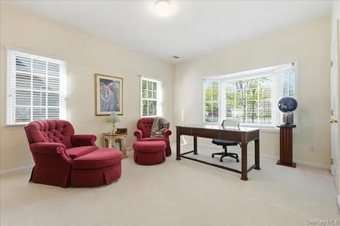 a living room with furniture and a floor to ceiling window