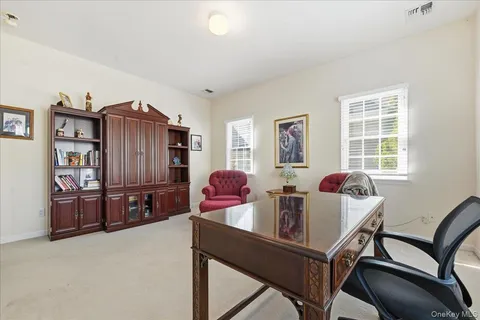 a living room with furniture a window and a flat screen tv