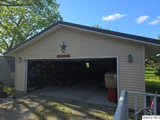 a view of a house with wooden deck and furniture