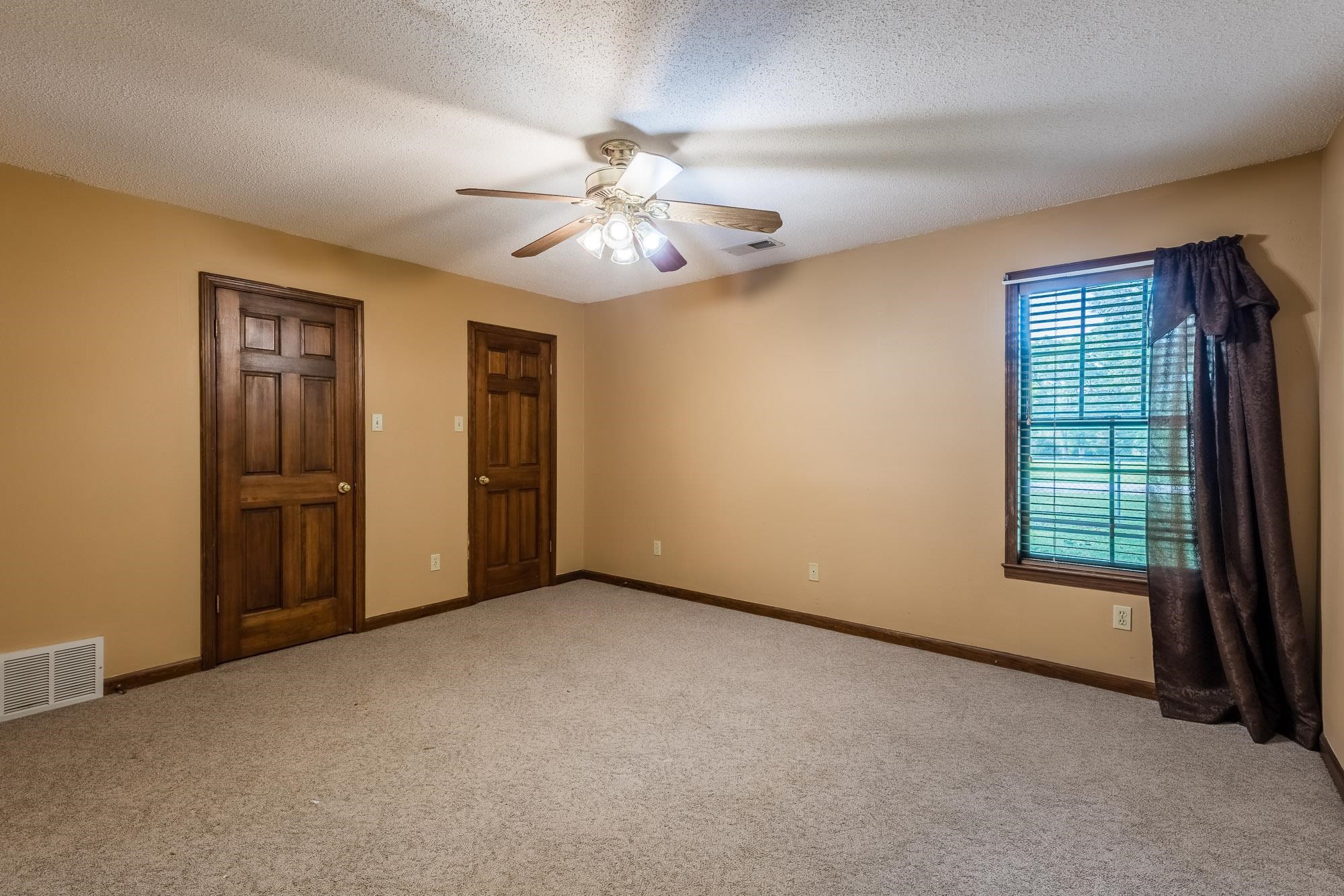 8670 Deadfall Road Millington, TN 38053 - Photo 17 of 25 an empty room with windows and fan