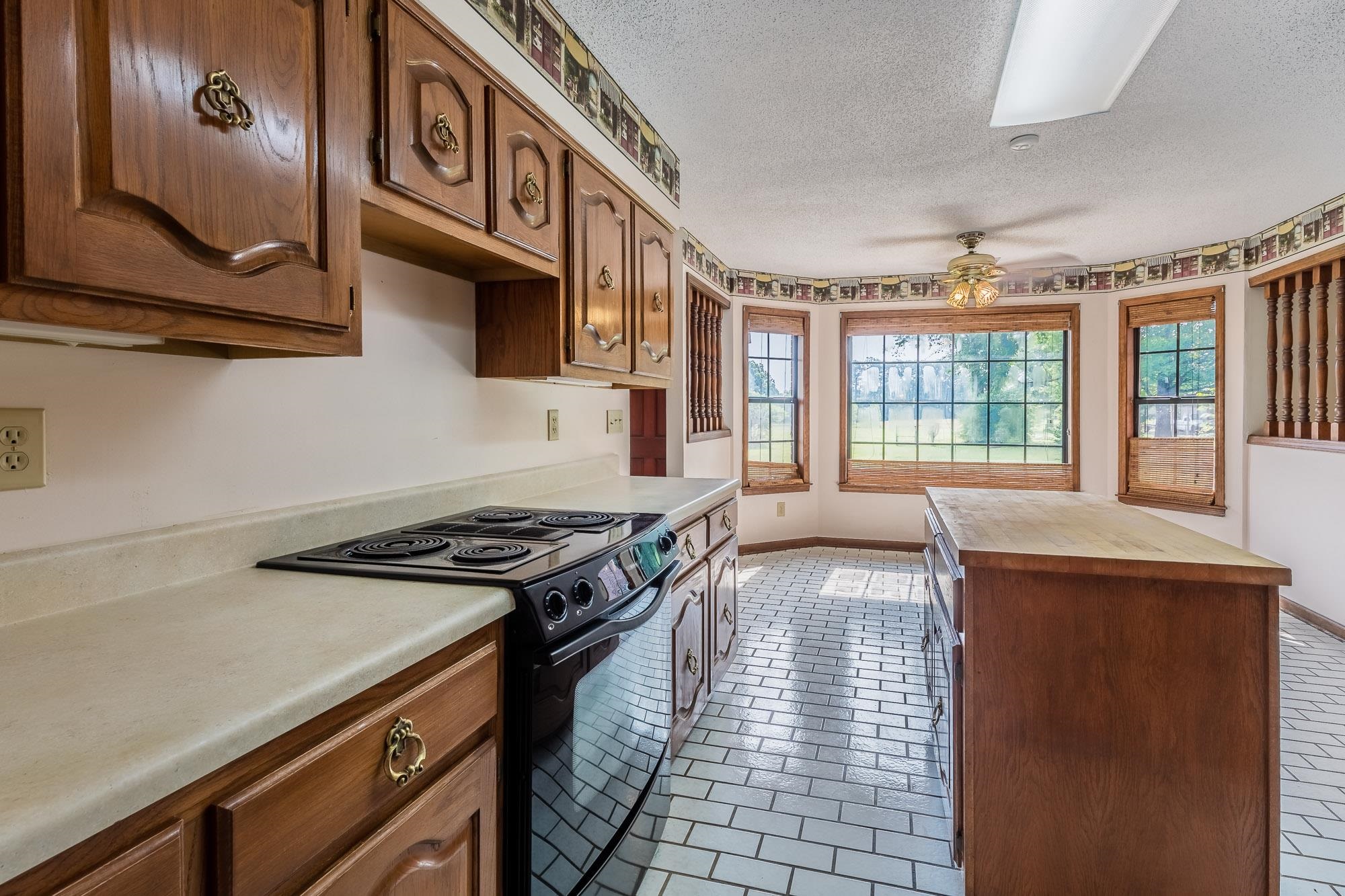 8670 Deadfall Road Millington, TN 38053 - Photo 7 of 25 a kitchen with granite countertop a stove and a sink