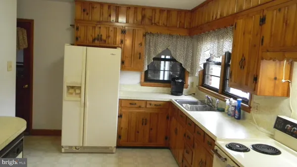 a kitchen with a sink a stove and cabinets