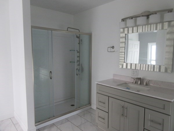 166 Knight Street Woonsocket, RI 02895 - Photo 17 of 22 a bathroom with a shower sink and mirror