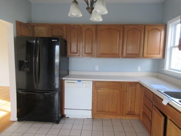 166 Knight Street Woonsocket, RI 02895 - Photo 5 of 22 a kitchen with a refrigerator and cabinets