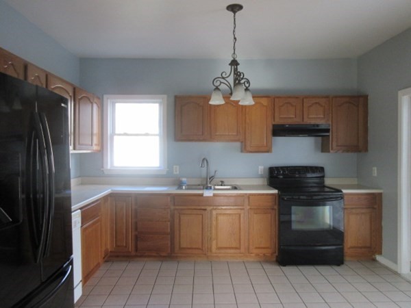 166 Knight Street Woonsocket, RI 02895 - Photo 6 of 22 a kitchen with a sink stove and refrigerator