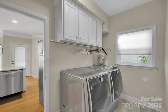 a utility room with sink dryer and washer