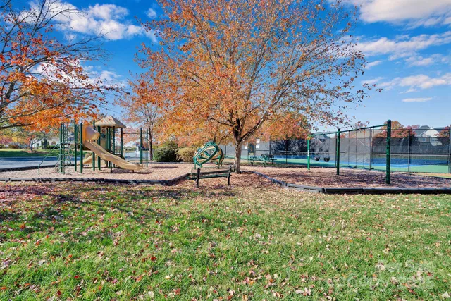 a view of a garden with a building in the background