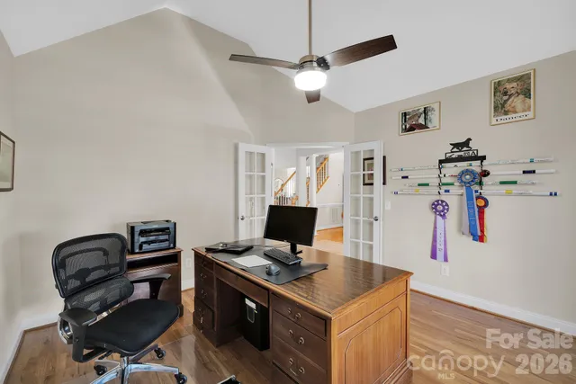 a kitchen with stainless steel appliances kitchen island granite countertop a sink and white cabinets