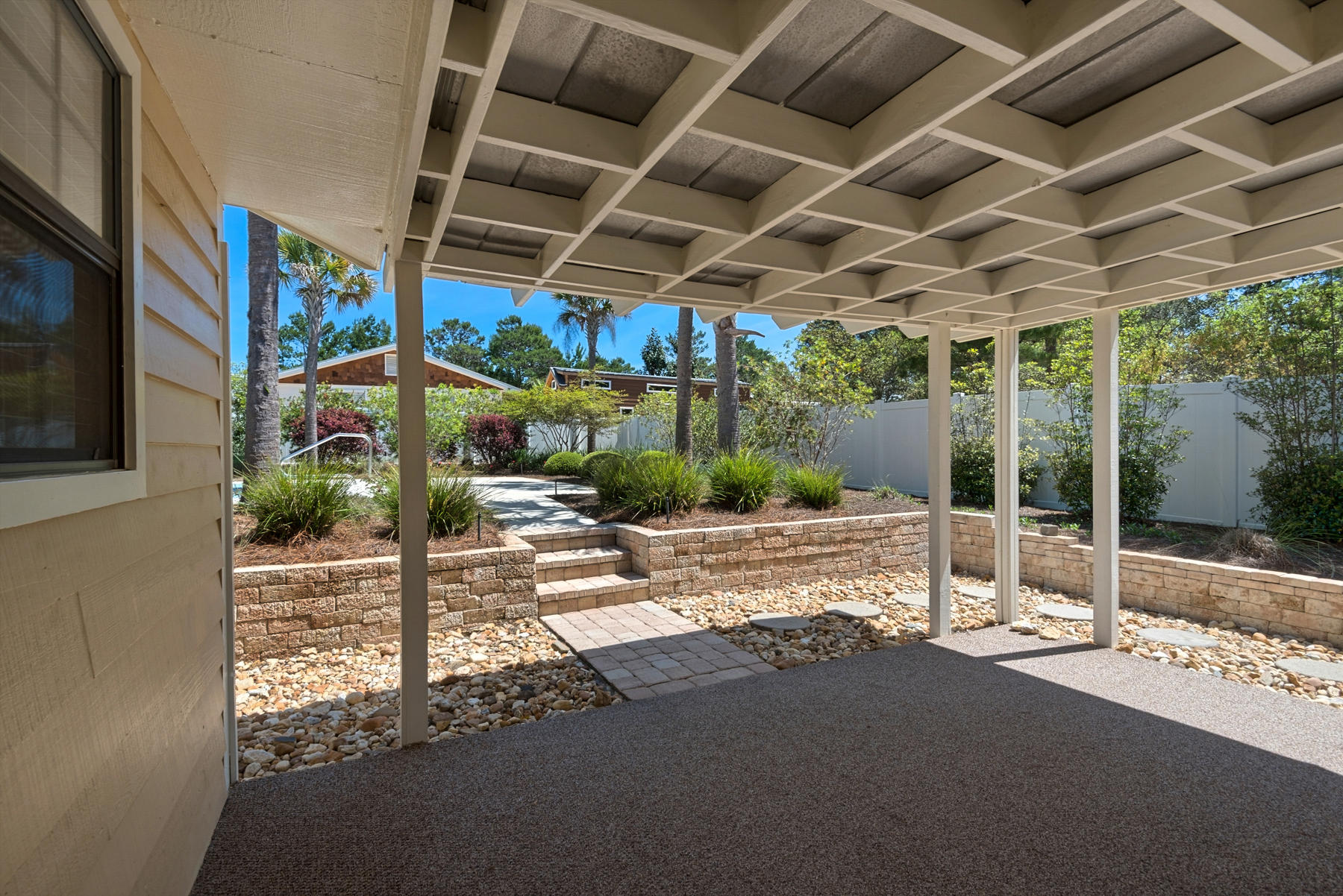 583 Ridge Road Santa Rosa Beach, FL 32459 - Photo 17 of 37 a view of a patio with table and chairs and potted plants