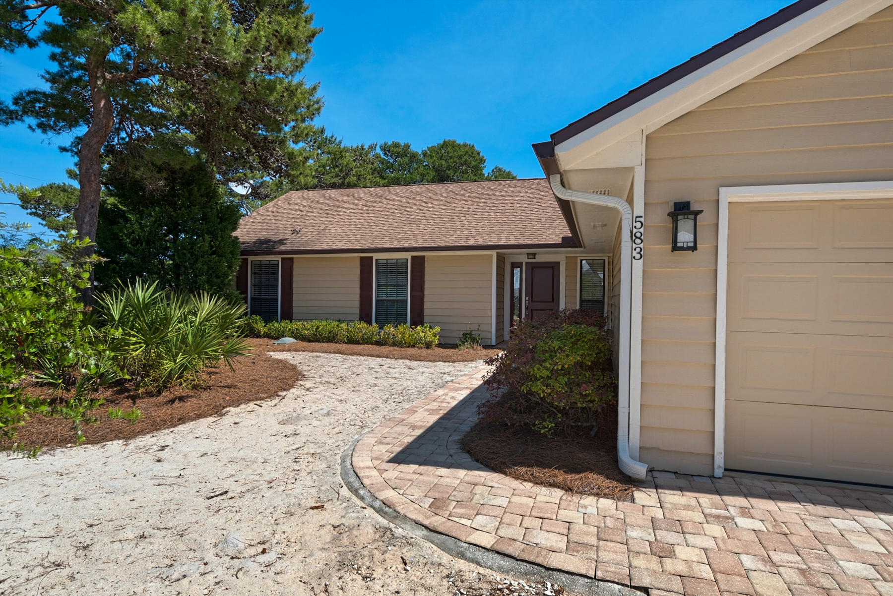 583 Ridge Road Santa Rosa Beach, FL 32459 - Photo 37 of 37 a view of a white house with a small yard and potted plants