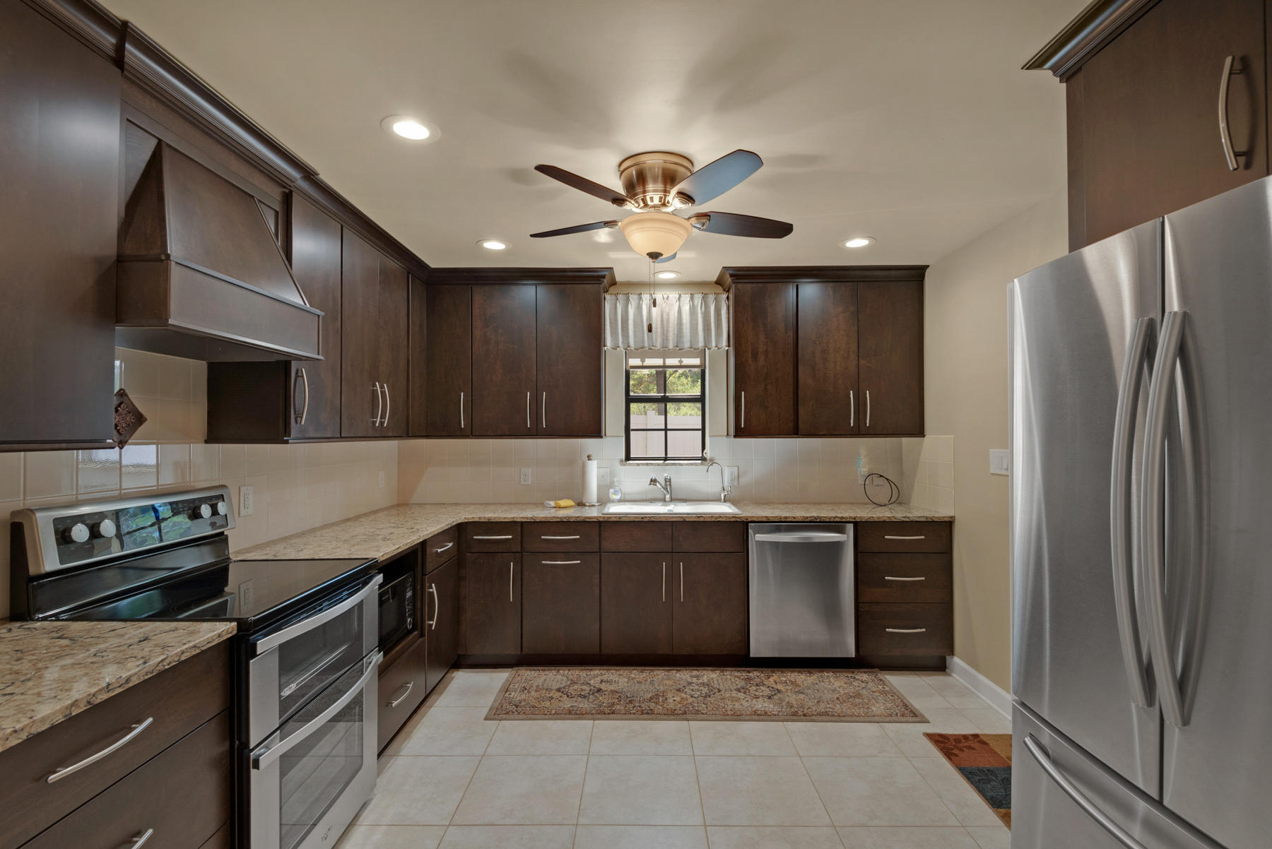 583 Ridge Road Santa Rosa Beach, FL 32459 - Photo 10 of 37 a kitchen with stainless steel appliances granite countertop a sink and a refrigerator