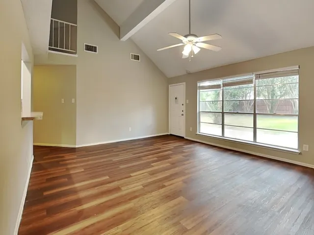 wooden floor in an empty room with a window