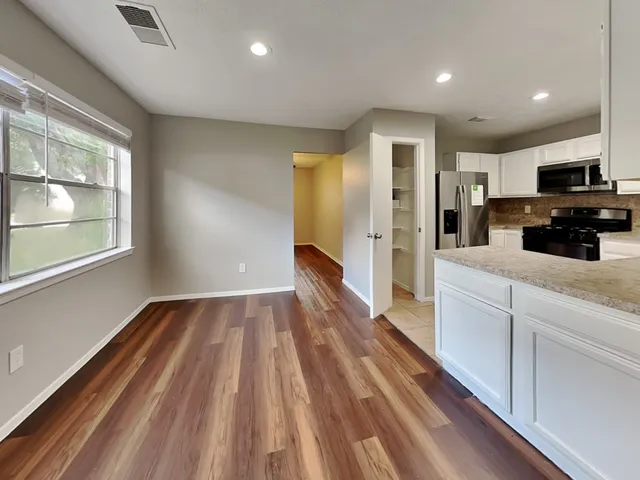 a view of kitchen with sink and refrigerator