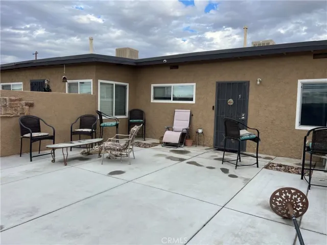 a view of a patio with table and chairs and potted plants