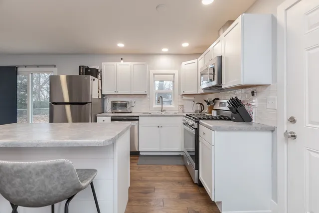 a kitchen with a refrigerator and a sink